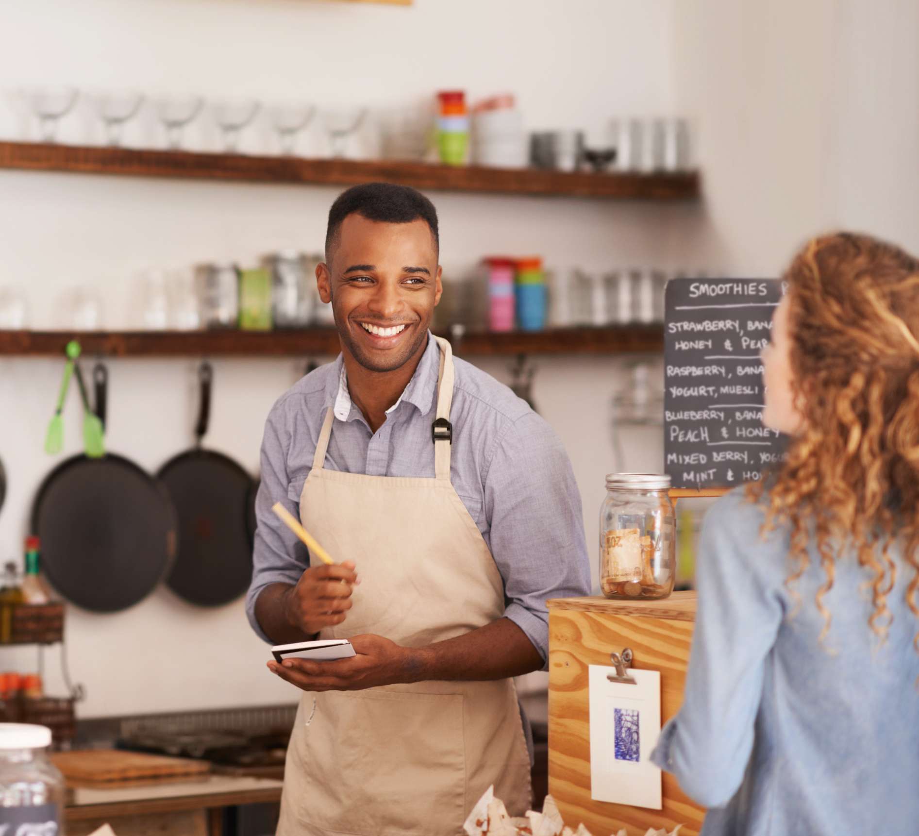 Café owner taking an order at the counter